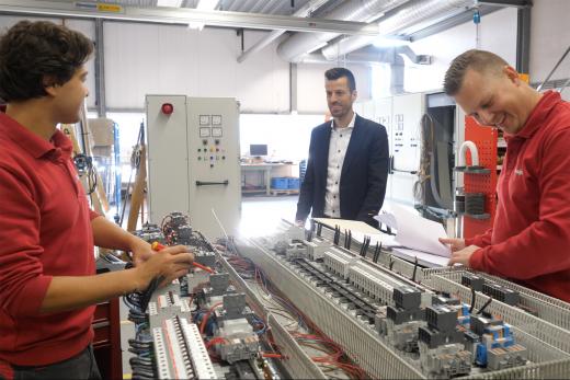  colleagues at work at switchboards and consoles